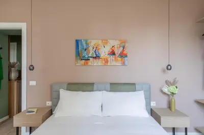 a bedroom with a bed and a painting on the wall at iFlat Saint Peter Green Chic Brand New Apartment in Rome