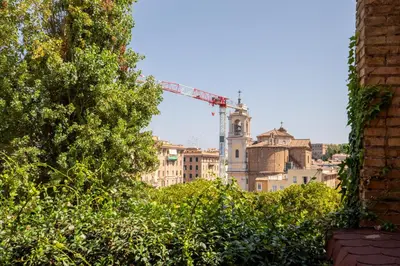 a view of a city with a crane in the background at iFlat Saint Peter Green Chic Brand New Apartment in Rome