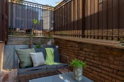 a blue bench with two pillows on a patio at iFlat Saint Peter Green Chic Brand New Apartment in Rome