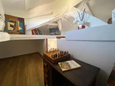 a small room with a chess board on a table at Il Tetto in Rome