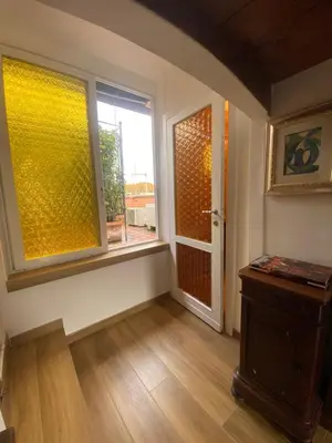 an empty room with a window and a door at Il Tetto in Rome