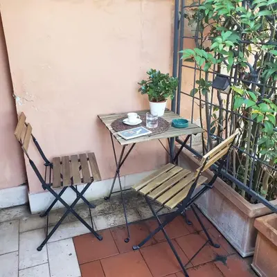 a table and two chairs sitting on a balcony at Il Tetto in Rome