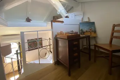 a room with a chess set on a table and a mirror at Il Tetto in Rome