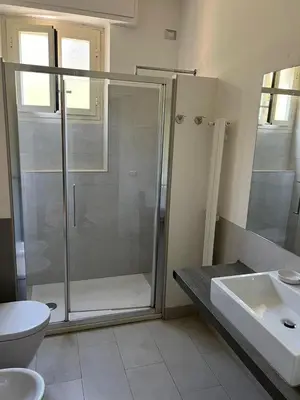 a bathroom with a shower and a toilet and a sink at Apartment Roma San Pietro in Rome