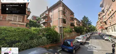 a street with cars parked on the side of a building at Apartment Roma San Pietro in Rome