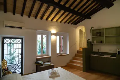 a kitchen with a staircase and a room with a table at Romantic Suite nel Cuore di Roma - Piazza Navona - in Rome