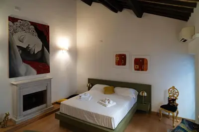 a bedroom with a white bed and a fireplace at Romantic Suite nel Cuore di Roma - Piazza Navona - in Rome