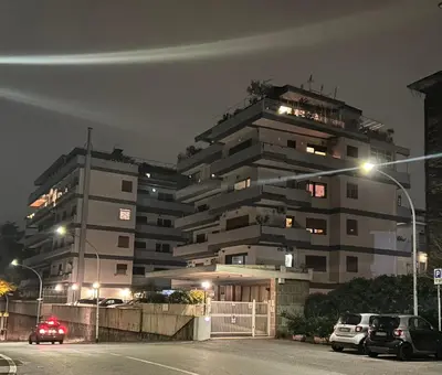 a building with cars parked in front of it at night at Rifugio Belsito in Rome