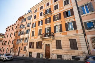 a large building with many windows on a street at la casa sul cortile in Rome
