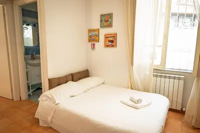 a white bed in a room with a window at la casa sul cortile in Rome