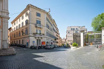 a cobblestone street in a city with buildings at la casa sul cortile in Rome