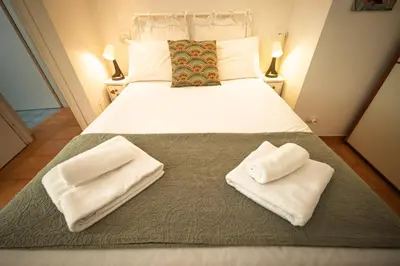 a bedroom with a bed with two towels on it at la casa sul cortile in Rome