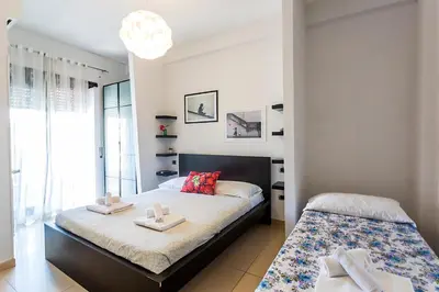 a bedroom with a bed with two towels on it at Naos C&G Hospitium in Rome