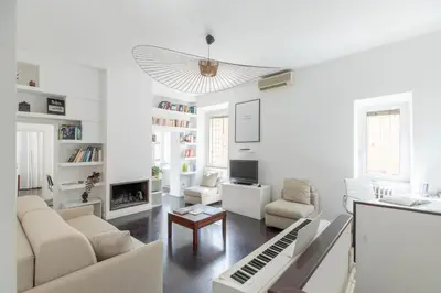 a living room with white furniture and a piano at iFlat Colosseum Modern & Peaceful Design Apt in Rome