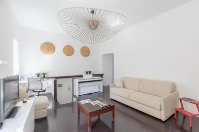 a living room with a couch and a tv at iFlat Colosseum Modern & Peaceful Design Apt in Rome