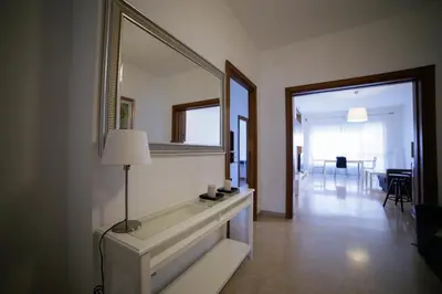 a living room with a large mirror on the wall at House in the City in Rome