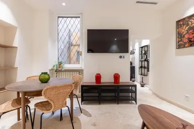 a dining room with a table and chairs and a window at Charming 3 Bedroom Apartment in the Historic Center in Rome