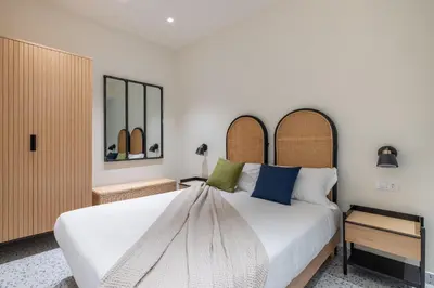 a bedroom with a large white bed and two mirrors at Charming 3 Bedroom Apartment in the Historic Center in Rome