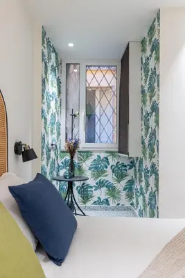 a bedroom with a bed with a window and a table at Charming 3 Bedroom Apartment in the Historic Center in Rome