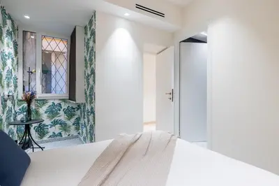 a bedroom with a white bed and a window at Charming 3 Bedroom Apartment in the Historic Center in Rome