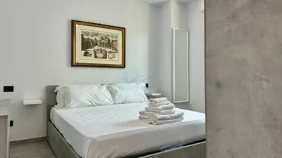 a bedroom with a bed with towels on it at Contemporary Comfort Stylish Modern Apartment in Rome