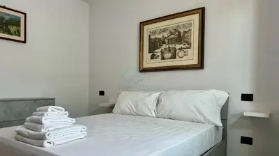 a bedroom with a bed with towels on it at Contemporary Comfort Stylish Modern Apartment in Rome