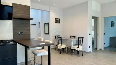 a kitchen and dining room with a table and chairs at Contemporary Comfort Stylish Modern Apartment in Rome