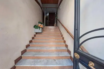 a stairway leading up to a building with a door at Eroi Spacious Apartment in Rome