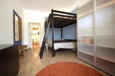 a bedroom with a bunk bed with a ladder at Garbatella 2BR Holiday House in Rome