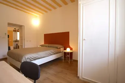 a bedroom with a bed and a table with a lamp at Garbatella 2BR Holiday House in Rome