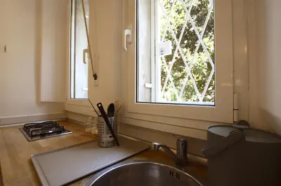 a kitchen with a sink and a window at Garbatella 2BR Holiday House in Rome