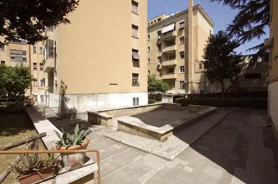 a courtyard with a fire pit in a building at Garbatella 2BR Holiday House in Rome
