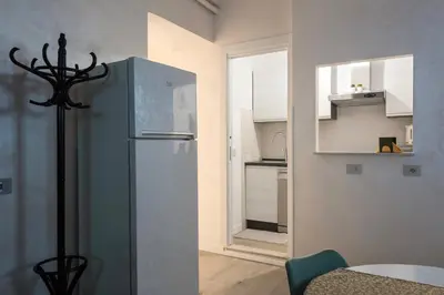 a kitchen with a refrigerator in a room at 2passi dal Colosseo in Rome