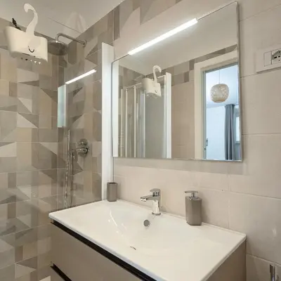a bathroom with a sink and a mirror at 2passi dal Colosseo in Rome