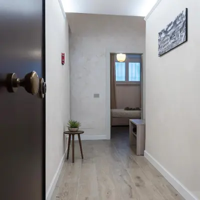 a hallway with a door open to a room at 2passi dal Colosseo in Rome