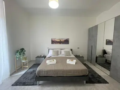 a bedroom with a large bed with two pillows at San Lorenzo Private Apartment in Rome