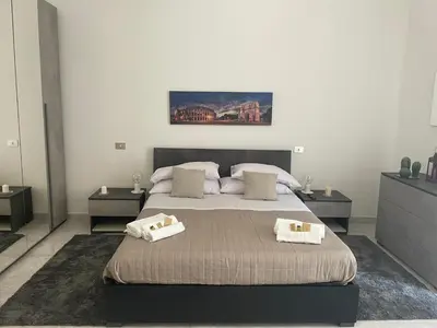 a bedroom with a bed with two pillows on it at San Lorenzo Private Apartment in Rome