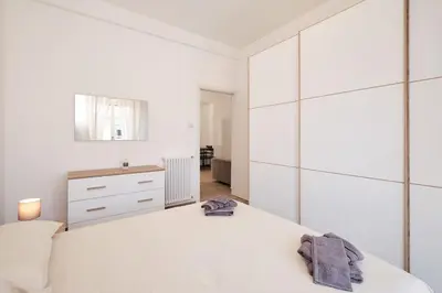 a white bedroom with a white bed and a dresser at Ospedale Gemelli-Vaticano Domus Di Pace 1BDR by Hôtea in Rome