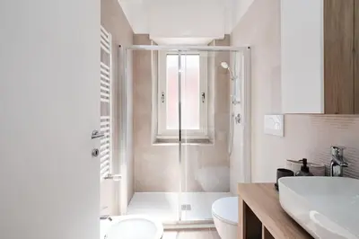 a bathroom with a shower and a toilet and a sink at Ospedale Gemelli-Vaticano Domus Di Pace 1BDR by Hôtea in Rome