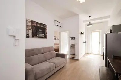 a living room with a couch and a television at Ospedale Gemelli-Vaticano Domus Di Pace 1BDR by Hôtea in Rome