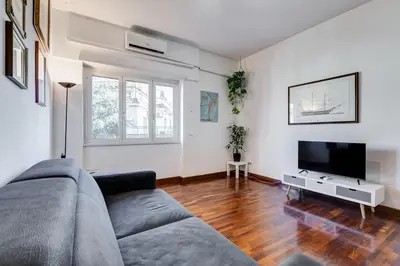 a living room with a couch and a flat screen tv at HYRIA Holiday Home in Rome