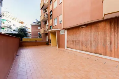 an empty parking lot next to a building at HYRIA Holiday Home in Rome