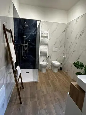 a bathroom with a shower and a toilet and a sink at MC Apartment Trastevere in Rome