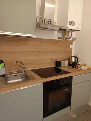 a living room with a table and a kitchen at MC Apartment Trastevere in Rome
