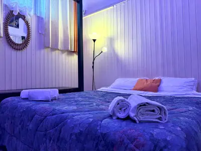 a bedroom with a bed with towels on it at L'atelier - mostra sospesa in Rome