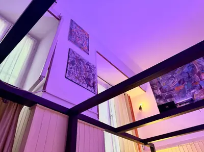 a room with a purple ceiling and some windows at L'atelier - mostra sospesa in Rome