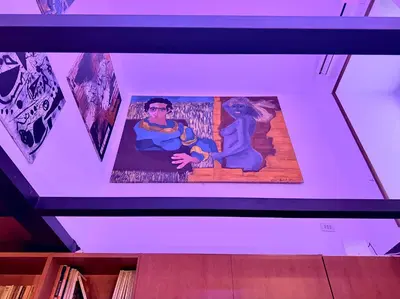a tv screen with a picture of a man and a woman at L'atelier - mostra sospesa in Rome