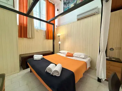 a bedroom with a bed with towels on it at L'atelier - mostra sospesa in Rome