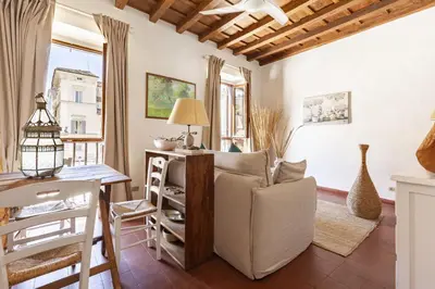 a living room with a couch and a table at Campo dei Fiori Luxury Gold in Rome