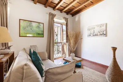 a living room with a couch and a window at Campo dei Fiori Luxury Gold in Rome